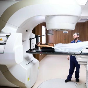 A patient (model) using a Linac MRI machine to scan her lungs